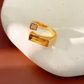 Elegant 18k gold plated geometric open ring featuring amber and clear zircon stones - Gold