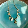 Detailed view of elegant gold ocean charms necklace with shells, starfish, and white pearls - Multi-Charm Metal Chain Necklace (4#)