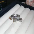 Detailed view of a luxury adjustable ring featuring double sparkling crystal bows - Silver-Grey