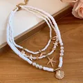 Detailed view of multi-strand necklace with polymer clay beads and starfish pendants - Triple Layered Marine Style / Gold/White