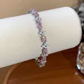 Detail shot of a sparkling flower bracelet with pink and white zircons on a display roll. - Silver-Light Pink