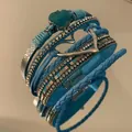 Close-up detail of Bohemian blue multi-layer leather bracelet with heart charm and crystals - Blue