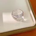 Detailed close-up of a silver-toned open ring with a clear resin bead on a jewelry box. - Threaded Oval Main Stone Style (HR3621) / Silver