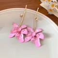 Exquisite pink enamel flower drop earrings featuring elegant golden branch stems for a chic look - Pink