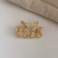 Elegant gold-plated flower stud earrings with shimmering clear cubic zirconia stones - Gold