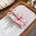 Close-up of Mori style floral fabric hair clips with a sweet and fresh design on a wooden tray. - Bowknot Duckbill Clip / Green Marijuana Leaf