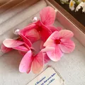 Detailed macro view of pink fabric flower earrings with white pearls and red beads - Silver Needle / Pink