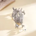 Silver anatomical heart brooch with sparkling rhinestones and crystal charms. - Silver