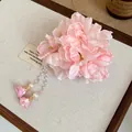 Close-up detail of pink fabric flower hair clip with elegant dangling pearl tassels. - Duckbill Clip - Single Piece / Pink