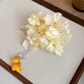 Detailed view of elegant fabric flower hair clip with yellow tassels and pearl accents - Duckbill Clip - Single Piece / Yellow