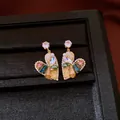 Detail of heart-shaped drop earrings with colorful gemstones and pearls in a black box - Waterdrop Heart Tassel Earrings (HE33940) / Gold