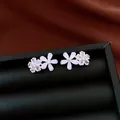 Detail shot of zircon and resin flower stud earrings on a black leather jewelry box - Double Flower Style (HE34094) / Silver Earring Post Style / Silver & White