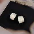 Detailed view of elegant C-shape stud earrings featuring a shimmering mother-of-pearl inlay - C-Shaped Style (HE32050) / Silver