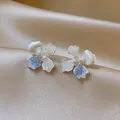 Detailed view of elegant silver flower stud earrings with colorful petals and central pearls - Silver Post Pink Blue Gradient