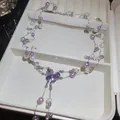 Detailed view of elegant purple pearl necklace with butterfly crystal pendant in box - Butterfly Tassel Style / White-Purple