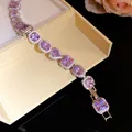 Close-up of elegant bracelet with sparkling purple heart and square shaped crystals - Fashion Bracelet / Purple