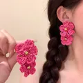 Handmade pink woven flower earrings with a romantic bohemian vacation vibe for women - Silver Earring Post / Rose Red