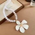 Detailed view of vintage French white beaded necklace with large resin flower pendant. - French Vintage Flower Style / Gold-White
