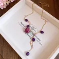 Close-up of stainless steel necklace with purple beads and resin everlasting rose pendant. - Purple Rose / Gold