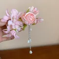 Exquisite pink cloth flower hair clip featuring long pearl tassels and bell charms. - Pink Rose Lily of the Valley Style