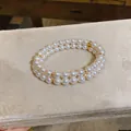 Elegant double-layered pearl bracelet with 18K gold-plated spacers on beige velvet - Gold-Pink