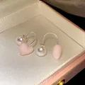 Close-up of elegant pink heart and white pearl drop earrings in a vintage jewelry box - Pink Heart & Pearl