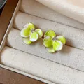 Close-up macro detail of green and white gradient flower earrings with zircon center - Style 2 (HE31329)