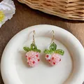 A high-quality detail view of handmade beaded strawberry earrings with pink glass beads - Hook-Pink (HE32481)