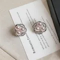 Detailed close-up of elegant floral hollow stud earrings with pink pearls and zircon stones. - Hollow Flower Stud / Silver Base Pink Pearl