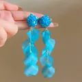 Detailed close-up view of blue crystal beaded earrings with cascading flower petals - Sapphire Blue Drop Style