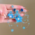 Detailed view of blue mesh flower crystal earrings with ethereal tassel design - Blue Crystal Tassel Mesh Style