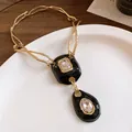 Vintage gold-toned twisted chain necklace with black enamel pendants and clear crystals. - Necklace (HN11818) / Gold Black