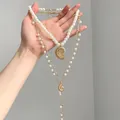 Detail shot of bohemian layered pearl necklace set with elegant gold conch pendant - Layered Conch Long Necklace / Gold-White