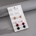 Macro view of a 12-piece set of square faux pearl stud earrings in diverse colors - Square Style (HE34123) / Set of 12 / Colorful