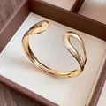 Detailed close-up showing the elegant polished gold waterdrop open cuff bracelet design - Teardrop Open Style / Gold