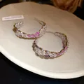 Close-up of silver-tone C-shaped hoop earrings with pink and white cubic zirconia stones. - C-Shape Geometric Style (HE32992) / Silver