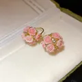 Close-up of exquisite pink resin flower ball earrings featuring sparkling rhinestones - Flower Basket Hoop Style / Pink