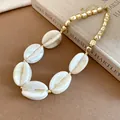 Close-up of acrylic marbled and golden beads necklace on a vintage book background - Necklace / Khaki