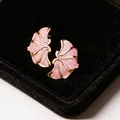 Elegant close-up of pink enamel flower stud earrings with gold trim on black velvet - Gold / Pink