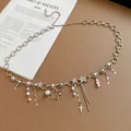 Close-up detail of silver-tone waist chain with faux pearls and rhinestone star charms - Star Pearl Tassel Style / 94cm / Silver