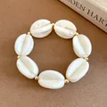 Detail of white marbled acrylic beads and gold spacers on a stylish stretch bracelet - Bracelet / Khaki