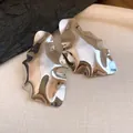 Macro view of silver irregular crumpled geometric earrings with high-gloss metallic finish - Geometric Pleated (Silver Post) / Silver
