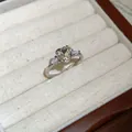 Detailed macro shot of vintage heart-shaped zircon silver adjustable ring in a display box - Silver