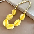 Chic women's beaded necklace with yellow marbled acrylic and gold metallic beads. - Necklace / Yellow