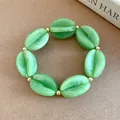 Green marbled acrylic beaded bracelet with coffee bean shaped charms - Bracelet / Green