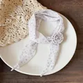 Detail of light purple skinny scarf with floral polka dots and fabric flower. - White