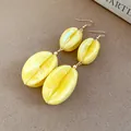 Elegant long drop earrings featuring yellow marbled acrylic beads and gold-toned hooks - Earring Hooks / Yellow