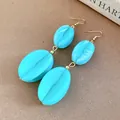 Stylish sky blue marbled acrylic drop earrings featuring coffee bean design with gold hooks - Earring Hooks / Cyan