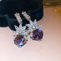 Detailed macro shot of elegant zircon earrings with purple gemstones and sparkling accents. - Geometric Rhombus Pendant Style (HE34186) / Silver-Purple