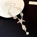 Elegant silver starfish and conch shell pendant necklace with a beach vacation style - Metal Conch Necklace (HN12203) / Silver